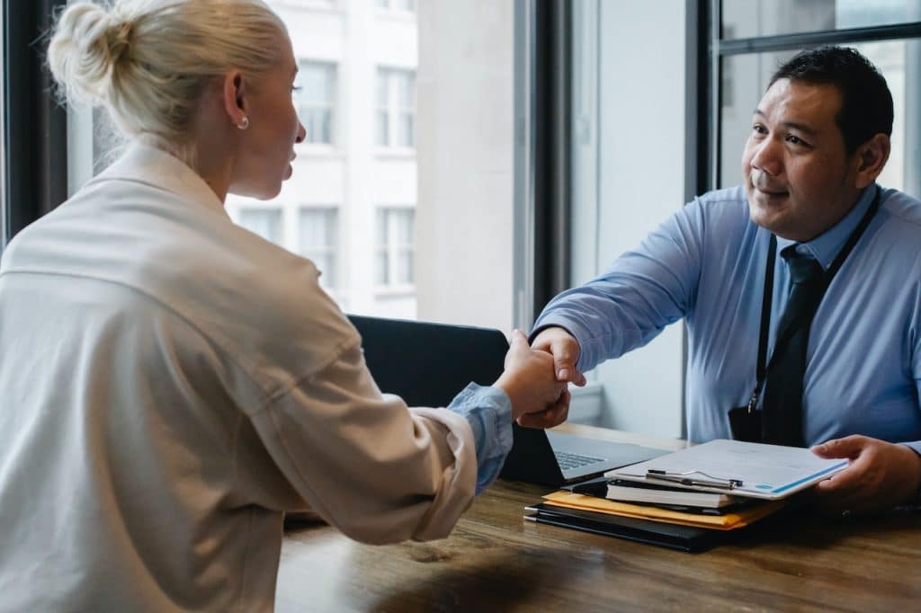 Data Interviewer shaking the hand of a potential candidate. 